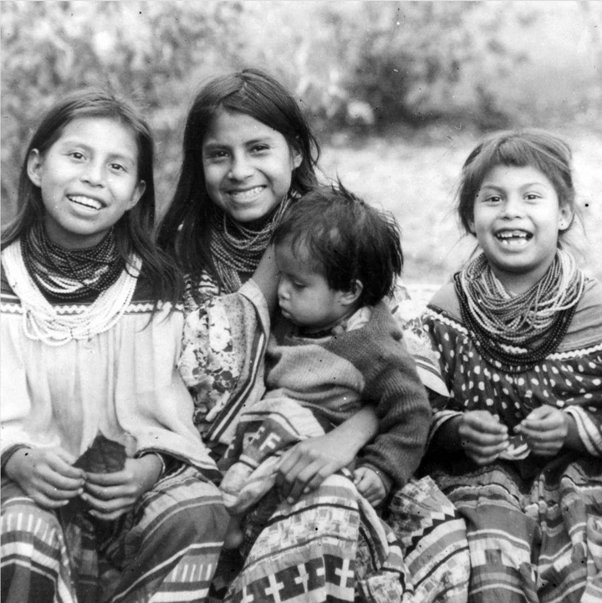 Historical photo of Miccosukee children in traditional patchwork clothing